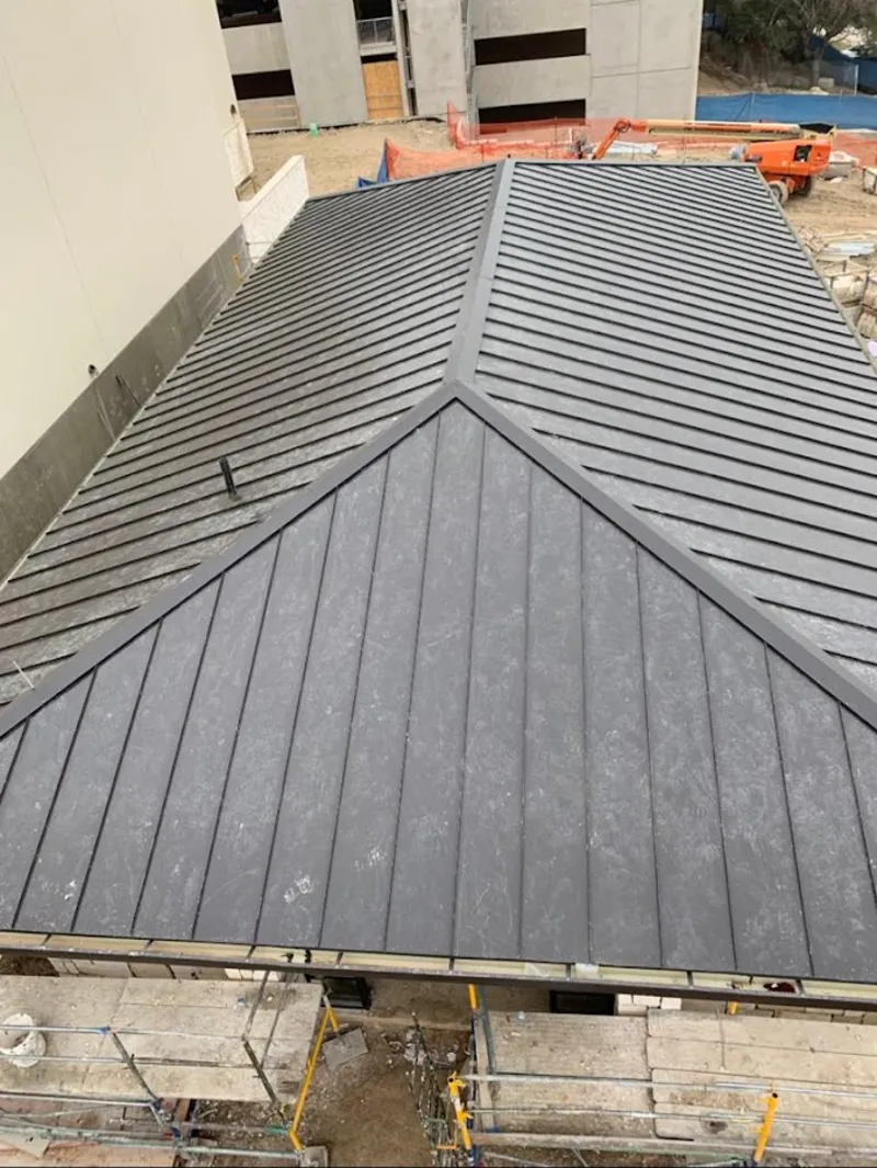 Commercial metal roof construction with crane equipment in Catskill